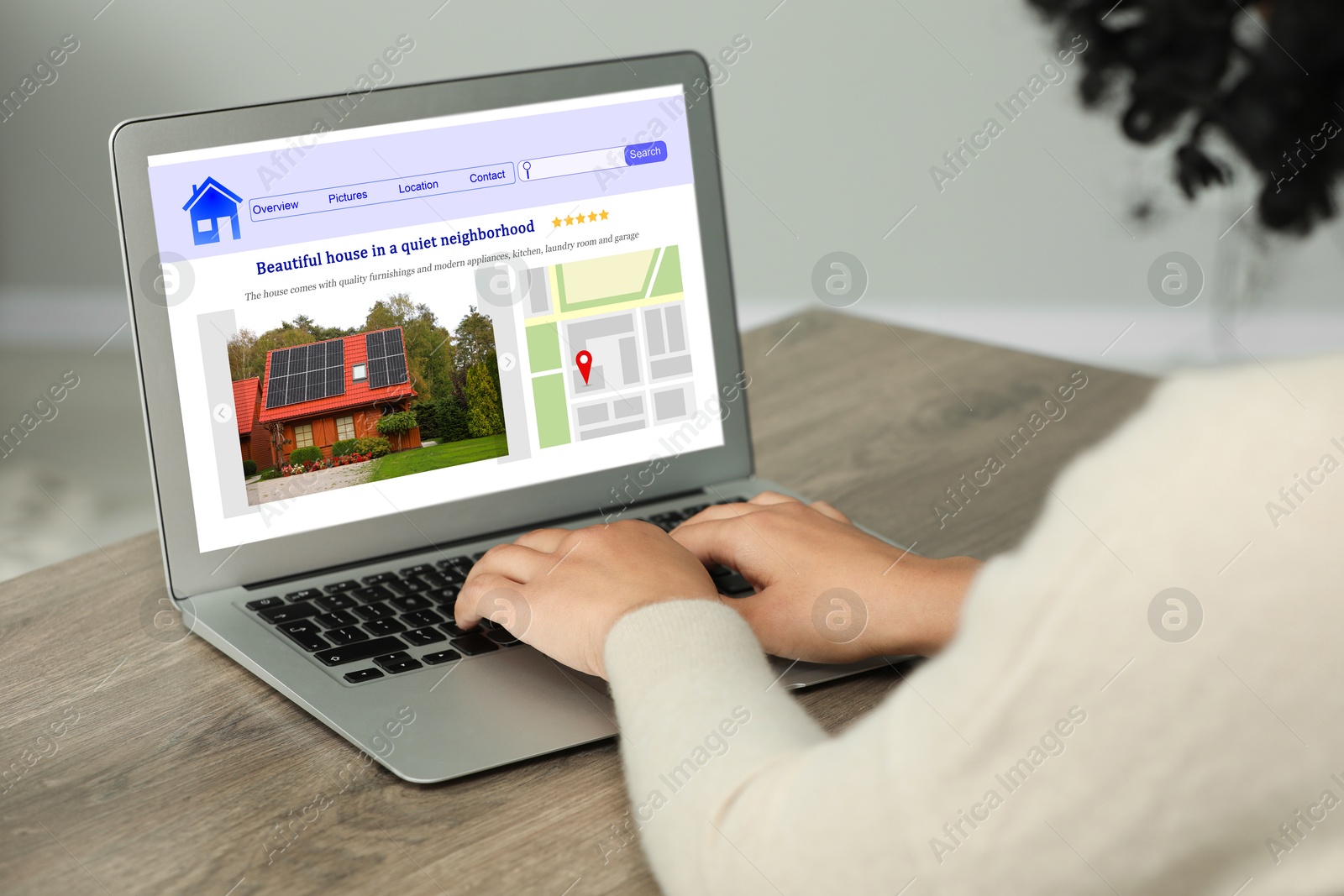 Image of Woman choosing dwelling on house hunting website via laptop at table, closeup