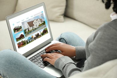 Woman choosing dwelling on house hunting website via laptop indoors, closeup