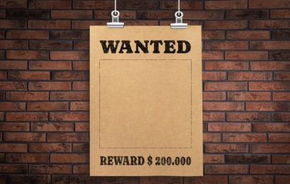 Image of Poster Wanted hanging on brick wall. Space for design