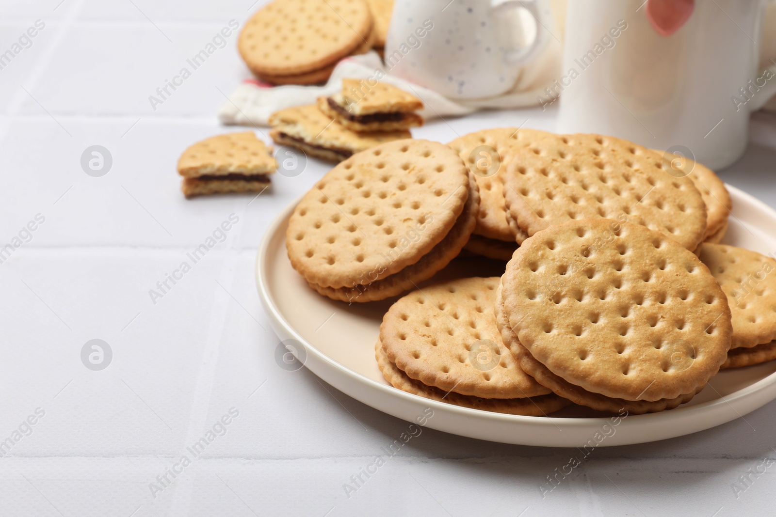 Photo of Tasty sandwich cookies on white table, closeup. Space for text