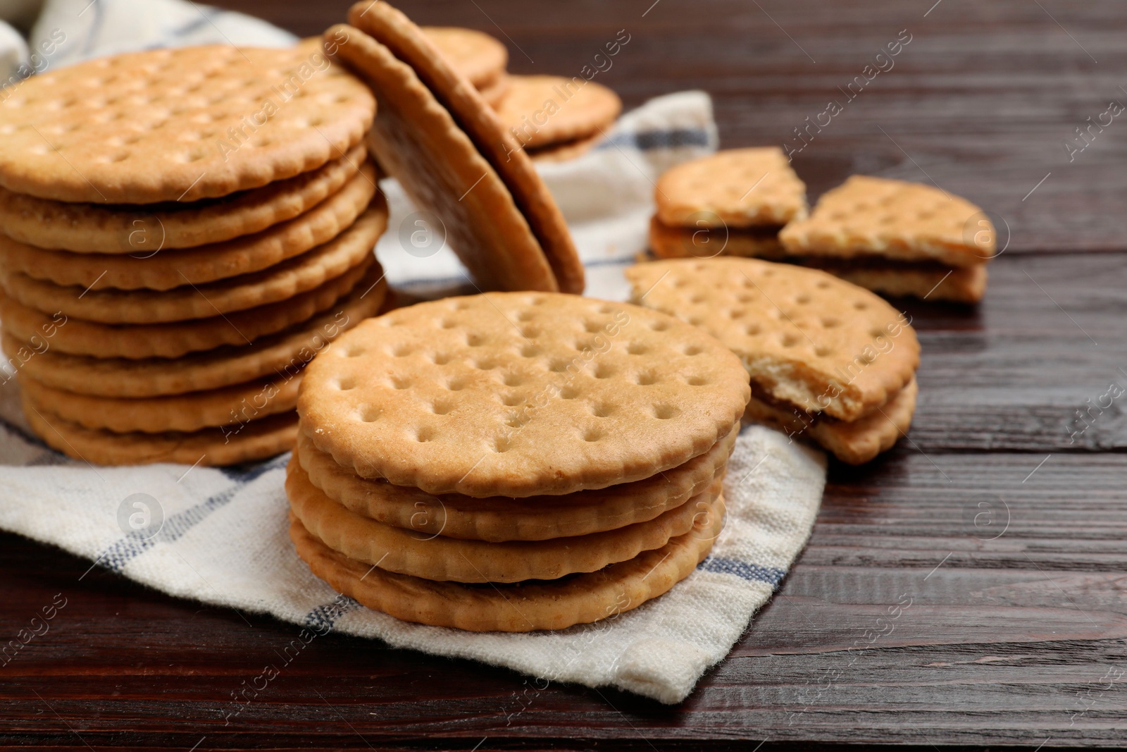 Photo of Tasty sandwich cookies on wooden table, closeup