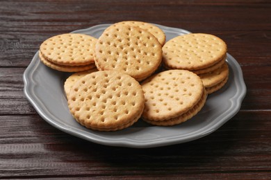 Photo of Tasty sandwich cookies on wooden table, closeup