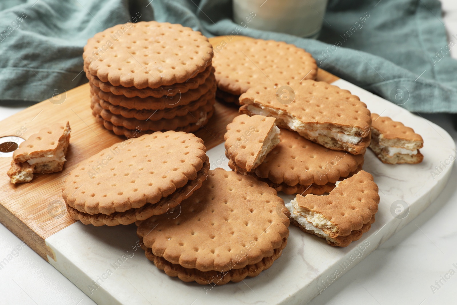 Photo of Tasty sandwich cookies on white table, closeup