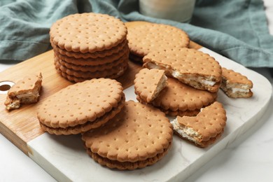 Tasty sandwich cookies on white table, closeup