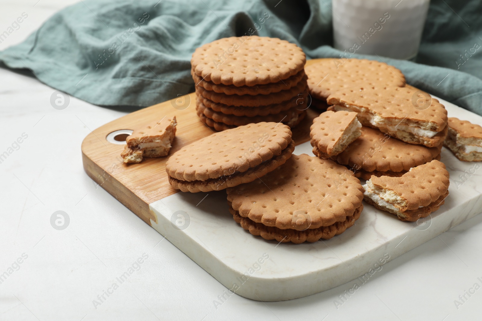 Photo of Tasty sandwich cookies on white table, closeup