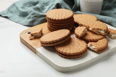 Photo of Tasty sandwich cookies on white table, closeup