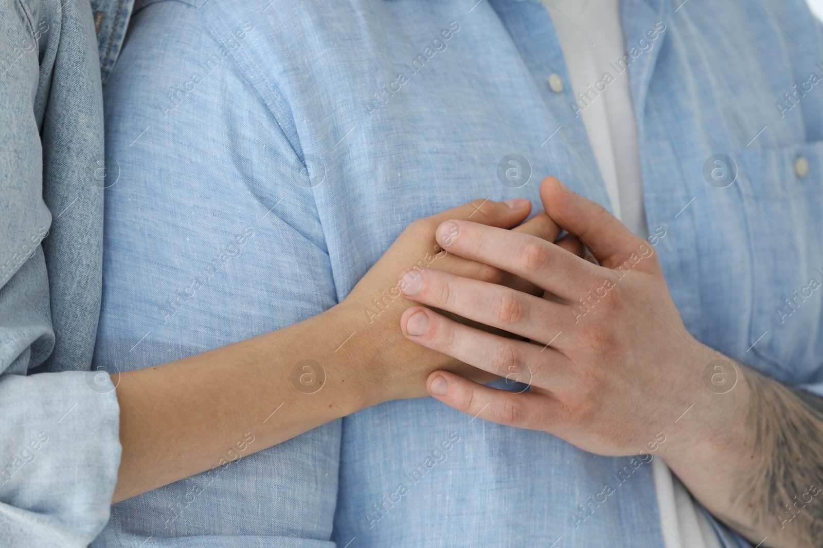 Photo of Couple holding hands, closeup view. Strong relationship