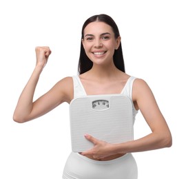 Photo of Diet and weight loss concept. Happy young woman with floor scale on white background