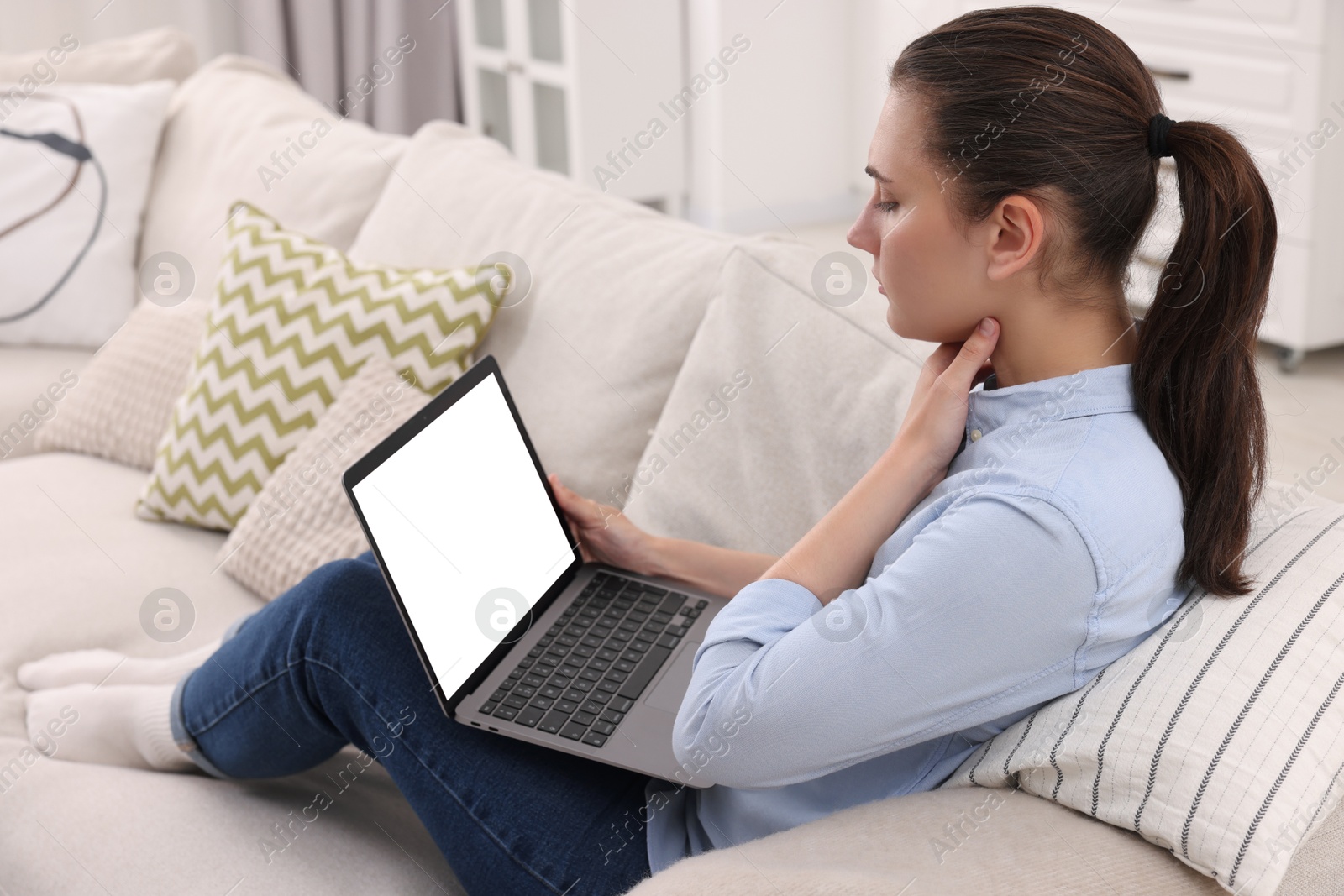 Photo of Sick woman having online consultation with doctor via laptop at home