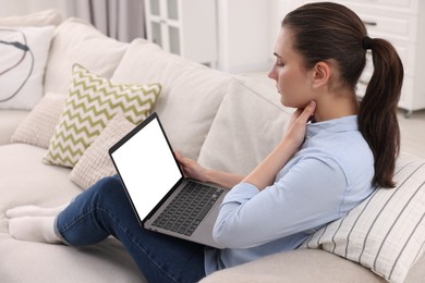 Sick woman having online consultation with doctor via laptop at home