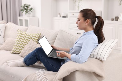 Sick woman having online consultation with doctor via laptop at home