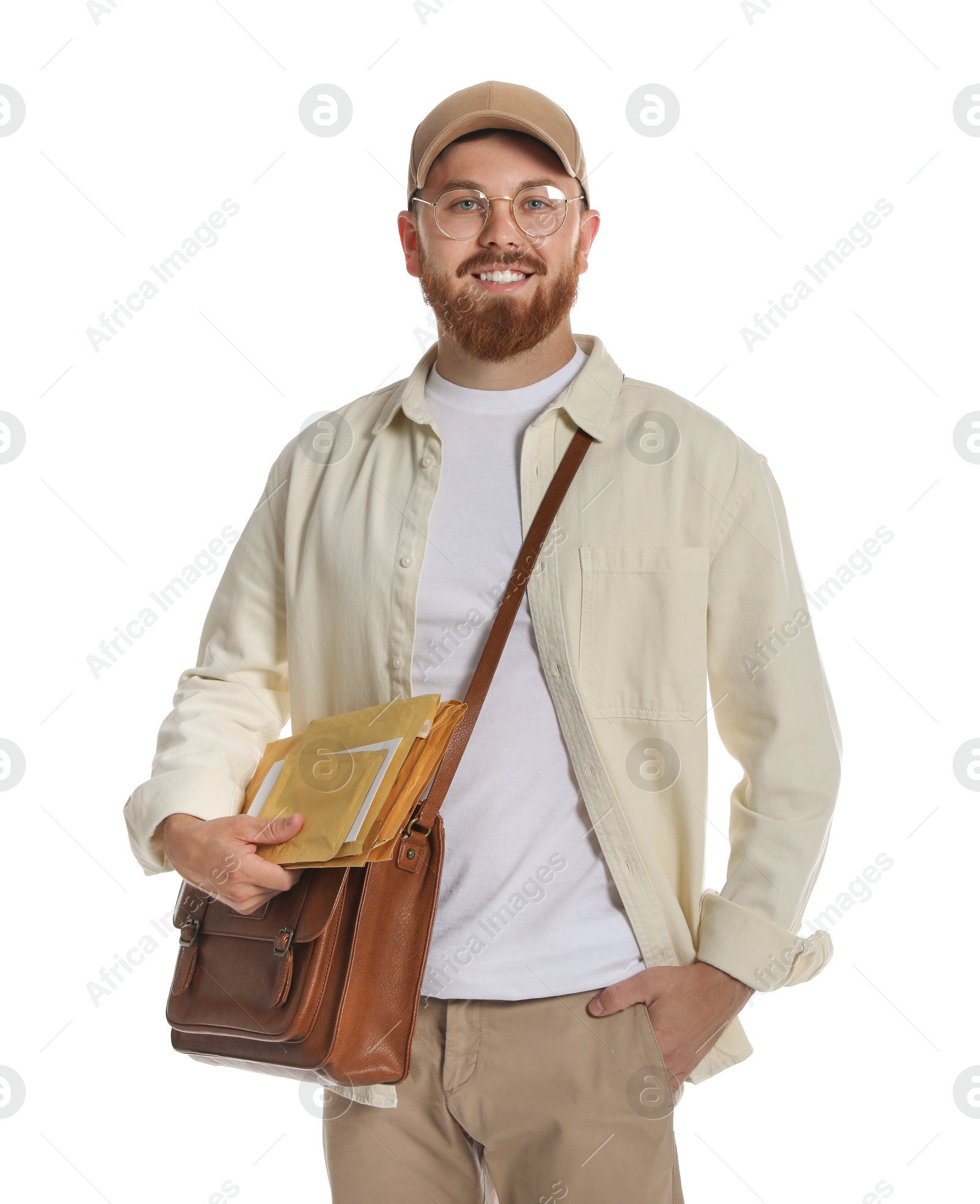 Photo of Happy young postman with brown bag delivering letters on white background