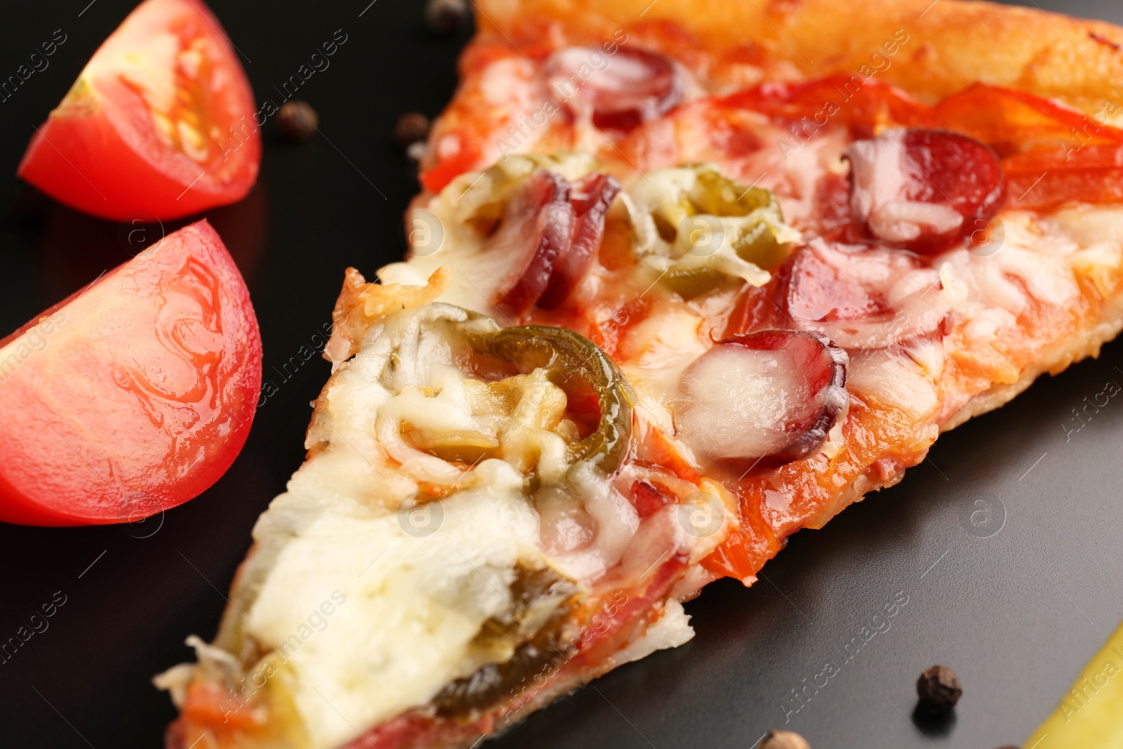 Photo of Delicious pizza Diablo and tomato on plate, closeup