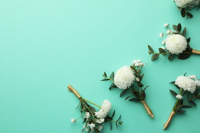 Many stylish boutonnieres on turquoise background, flat lay. Space for text