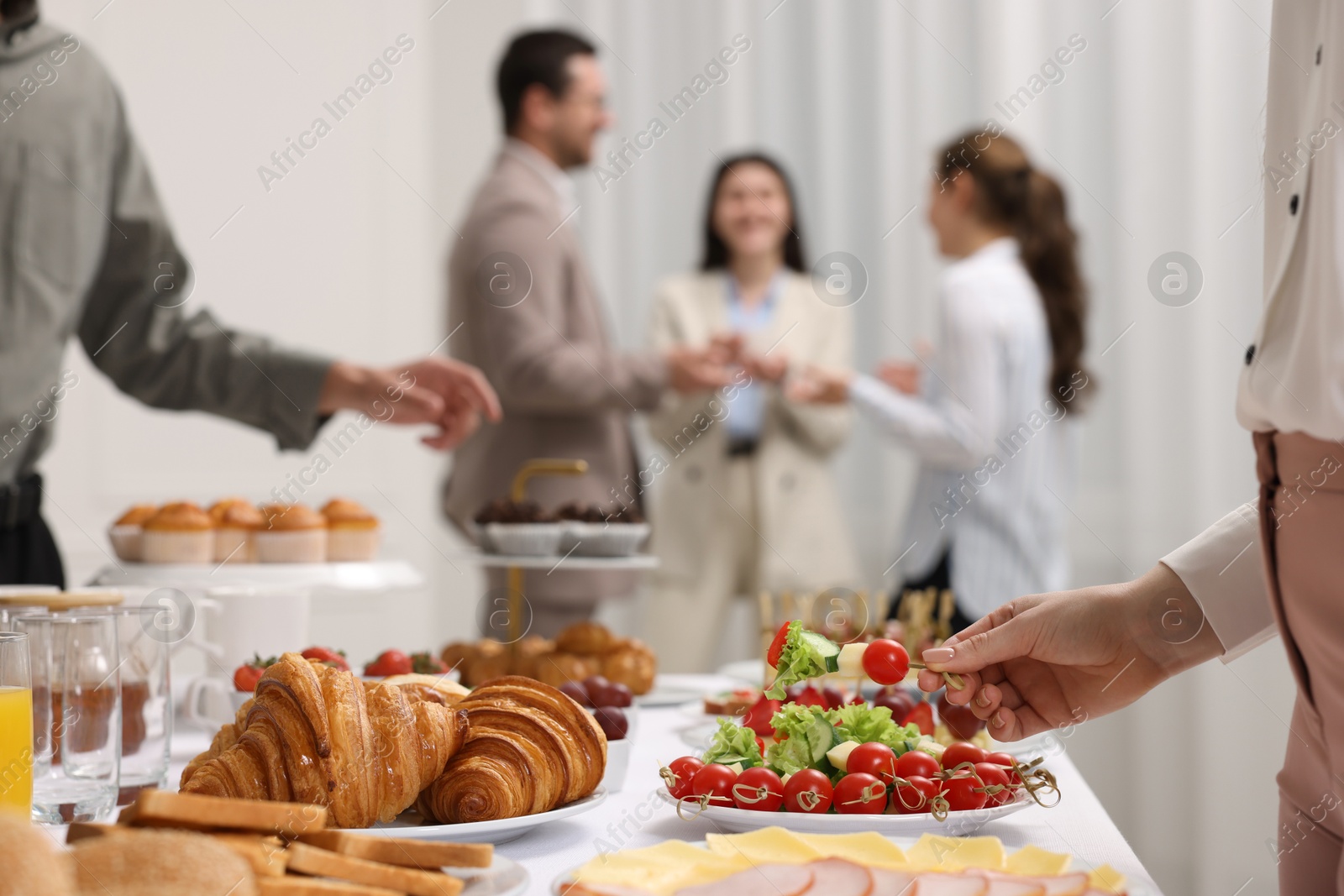 Photo of Coworkers having business lunch in restaurant, closeup