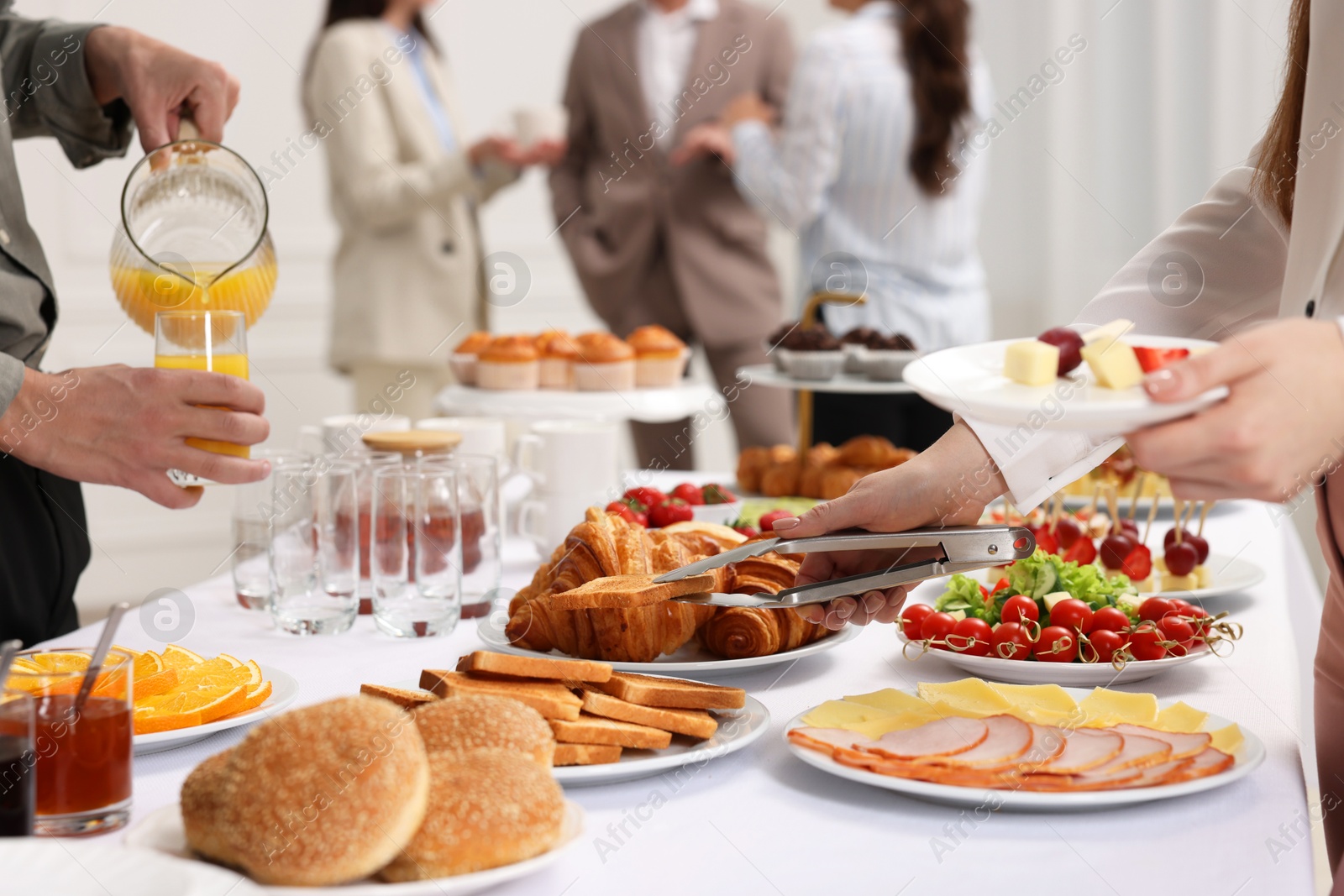 Photo of Coworkers having business lunch in restaurant, closeup