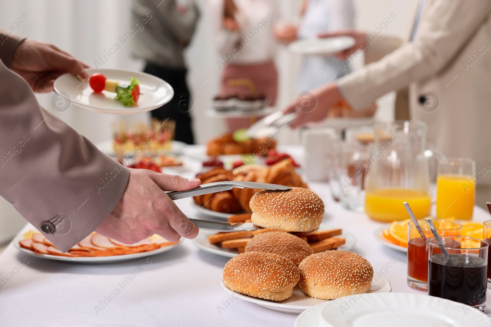 Photo of Coworkers having business lunch in restaurant, closeup