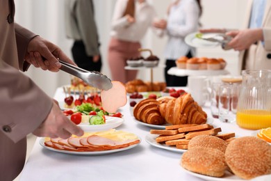 Coworkers having business lunch in restaurant, closeup