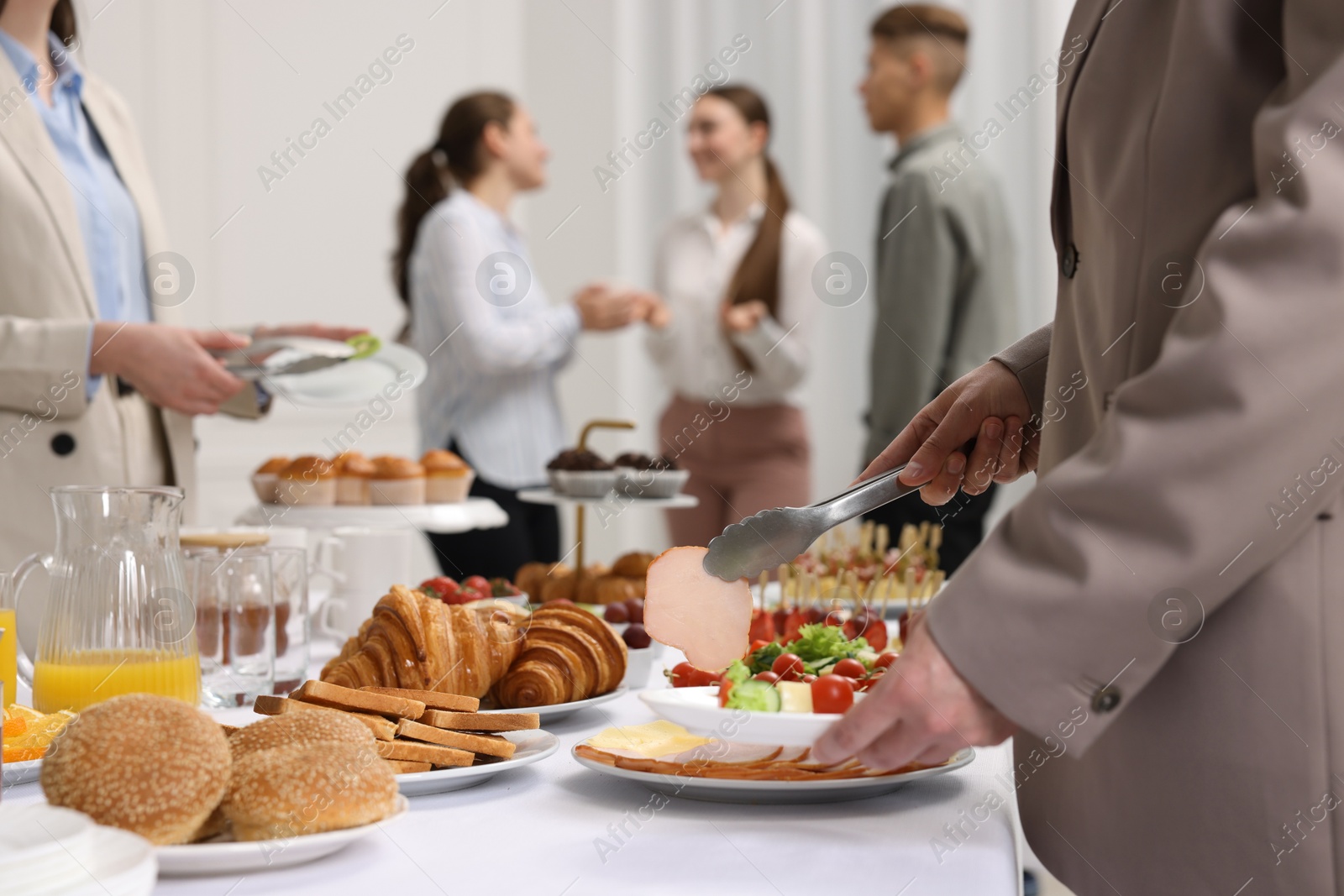 Photo of Coworkers having business lunch in restaurant, closeup