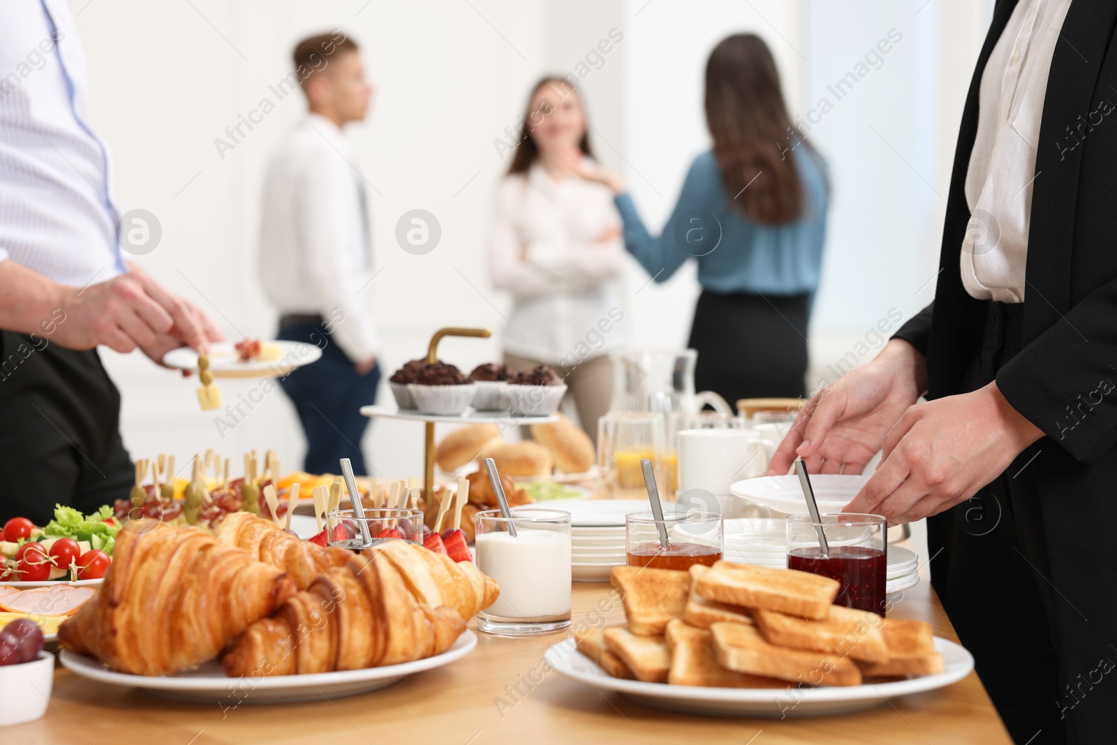 Photo of Coworkers having business lunch in restaurant, closeup