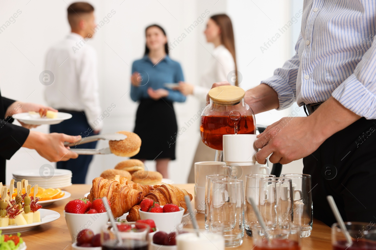 Photo of Coworkers having business lunch in restaurant, closeup