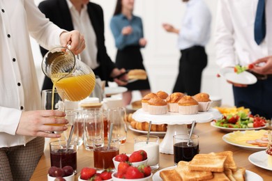 Coworkers having business lunch in restaurant, closeup