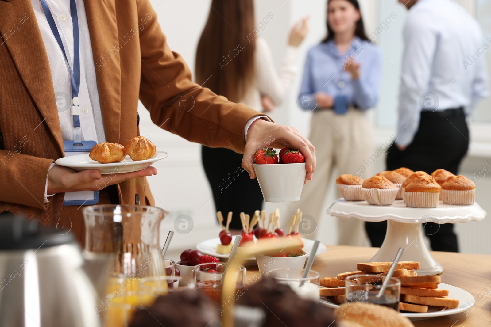 Photo of Coworkers having coffee break in office, closeup