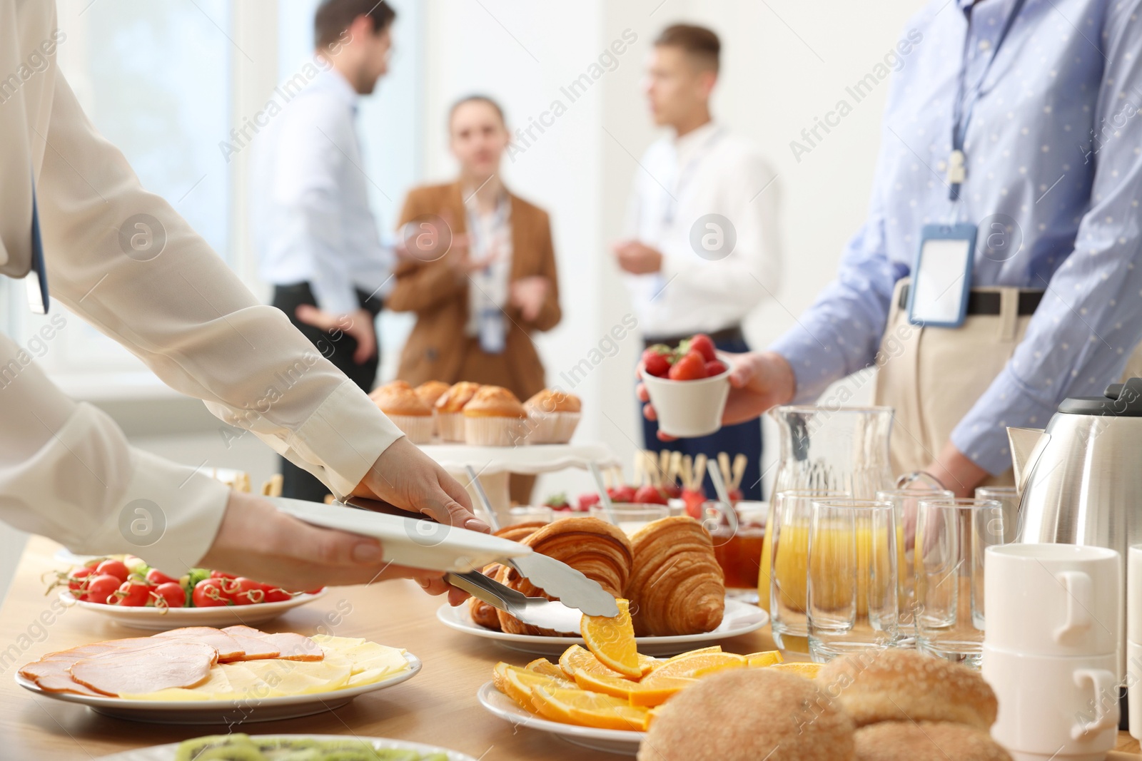 Photo of Coworkers having business lunch in restaurant, closeup