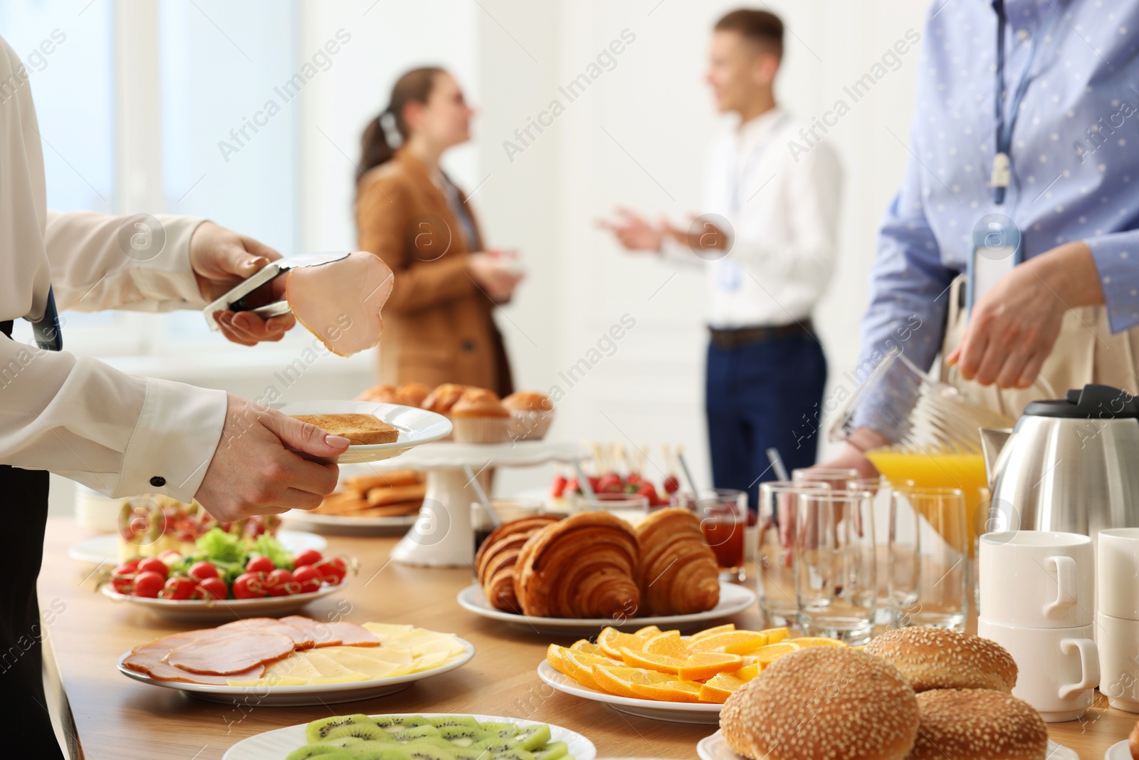 Photo of Coworkers having business lunch in restaurant, closeup