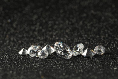 Beautiful dazzling diamonds on dark shiny background, closeup