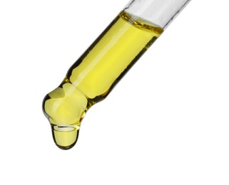 Photo of Dripping essential oil from pipette on white background