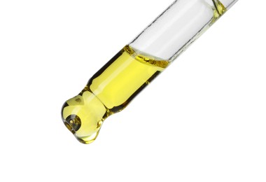 Photo of Dripping essential oil from pipette on white background