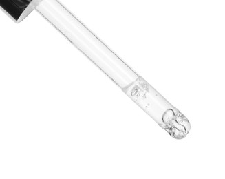 Photo of Dripping cosmetic serum from pipette on white background