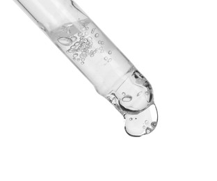 Photo of Dripping cosmetic serum from pipette on white background