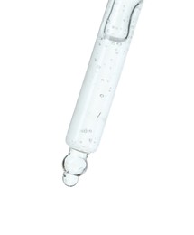 Dripping cosmetic serum from pipette on white background