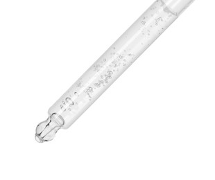 Dripping cosmetic serum from pipette on white background