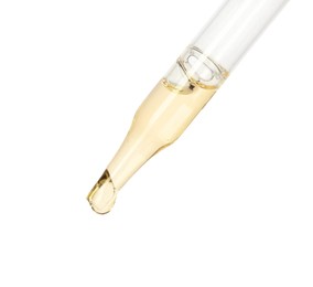 Photo of Dripping essential oil from pipette on white background