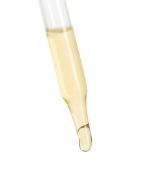 Dripping essential oil from pipette on white background