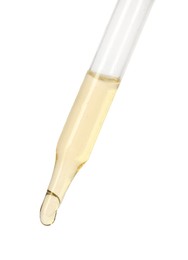 Dripping essential oil from pipette on white background