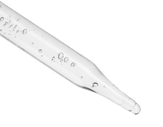 Photo of Dripping cosmetic serum from pipette on white background