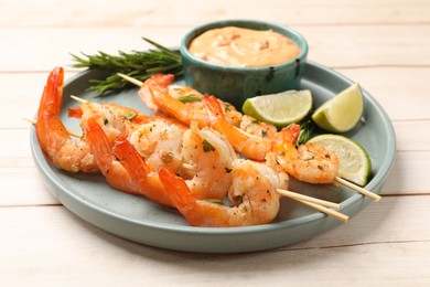 Photo of Skewers with delicious grilled shrimps served on white wooden table, closeup