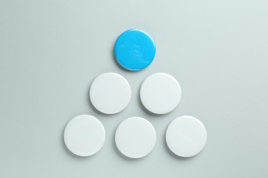 Blank button badges on light background, flat lay. Mockup for design