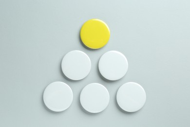 Photo of Blank button badges on light background, flat lay. Mockup for design