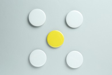 Blank button badges on light background, flat lay. Mockup for design