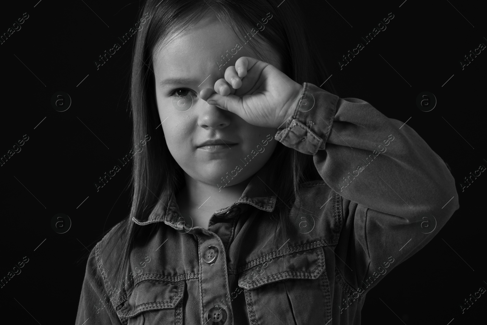 Photo of Portrait of sad girl on dark background, closeup. Black and white effect