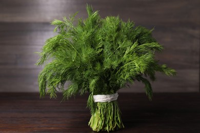 Photo of Bunch of fresh green dill on wooden table