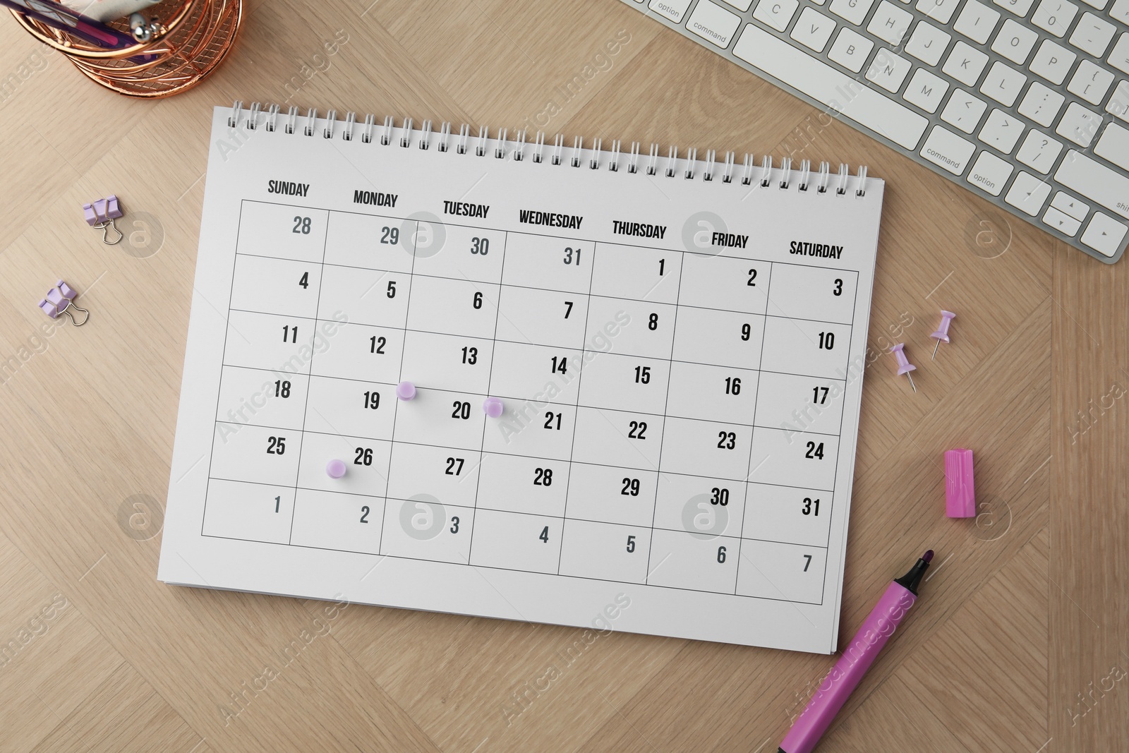 Photo of Timetable. Calendar, stationery and keyboard on wooden table, flat lay