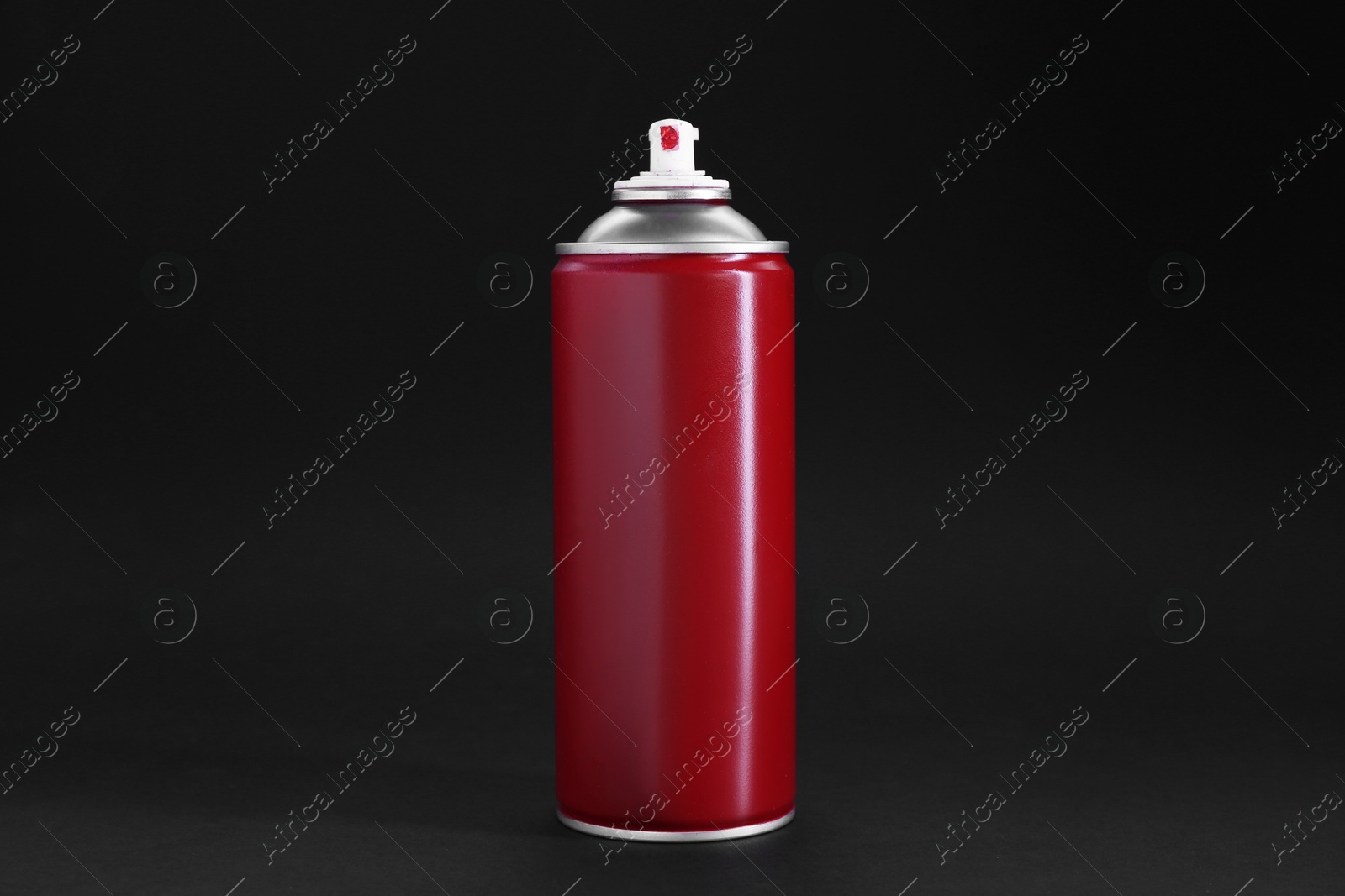 Photo of Red spray paint can on dark gray background