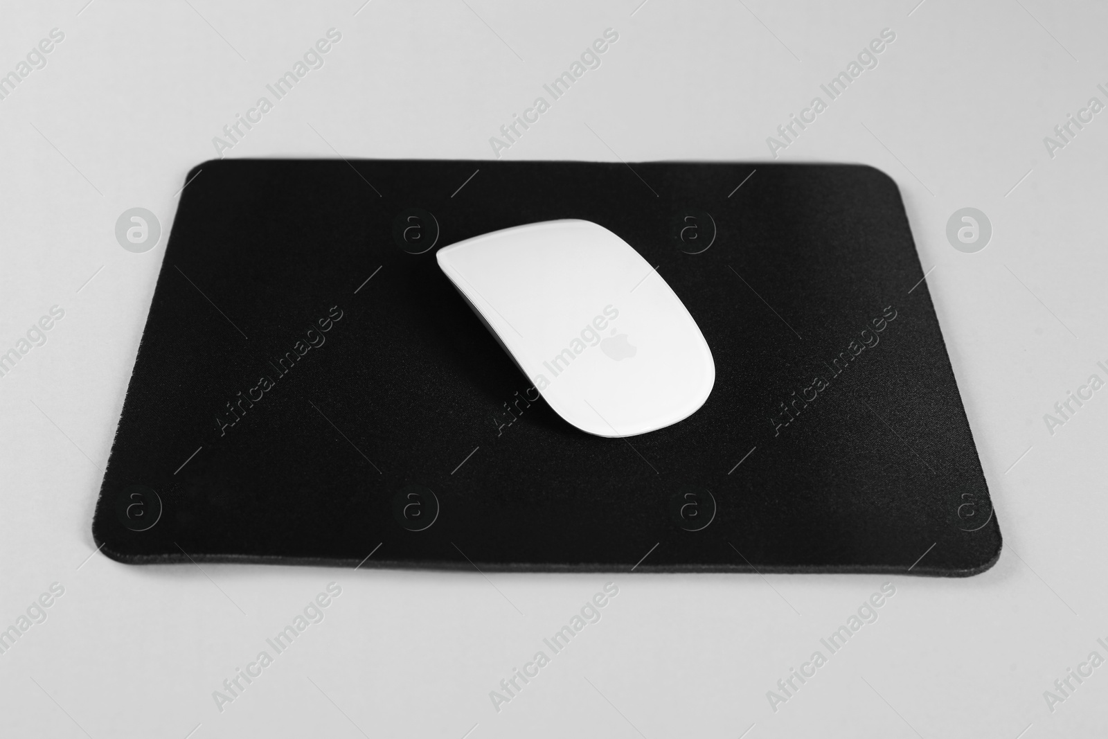 Photo of Wireless mouse and mousepad on white background