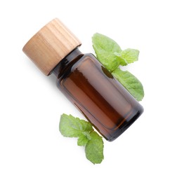 Photo of Bottle of essential oil and mint isolated on white, top view